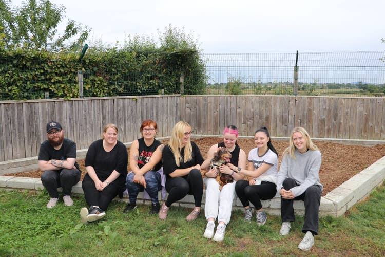 Our team visiting the Cotswold Dogs and Cats Home sitting proudly on the edge of the garden they cleared out.
