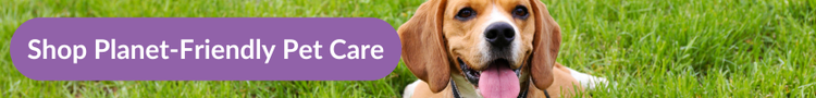 A beagle panting while laying in grass with overlaytext that reads &#34;Shop Planet-friendly Pet Care&#34;